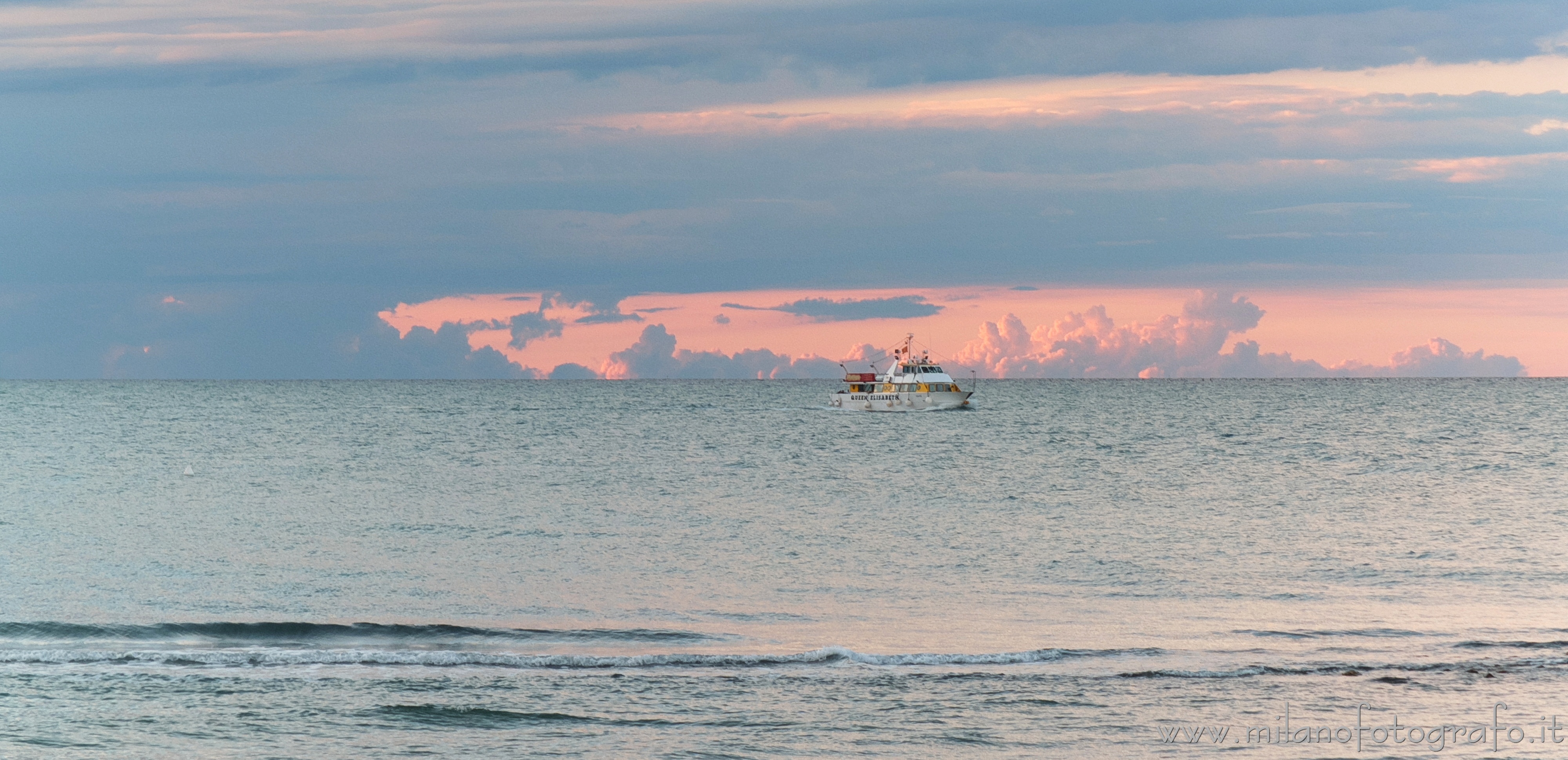 Cattolica (Rimini, Italy) - Motor ship Queen Elizabeth returning to port at sunset